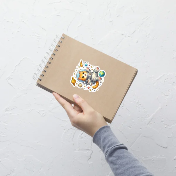 Astronaut cat kiss-cut vinyl sticker featuring cute orange tabby in spacesuit